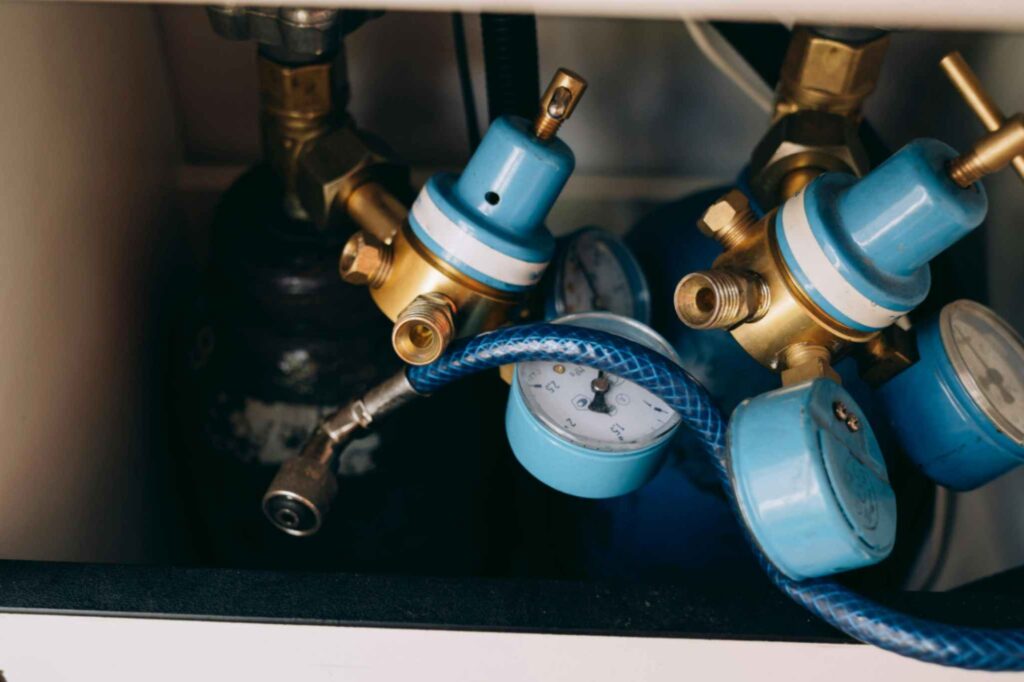 Gas regulator and flow meters connected to industrial equipment